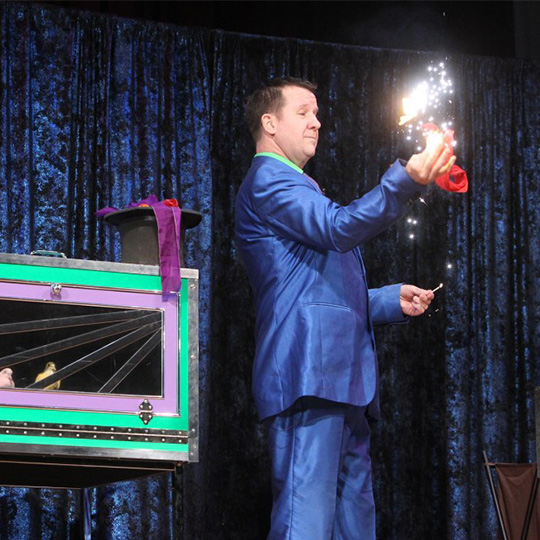 Magician on stage performing