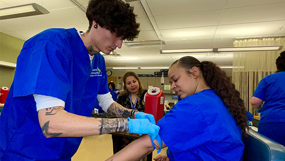 Medical Assistant students checking vitals. 