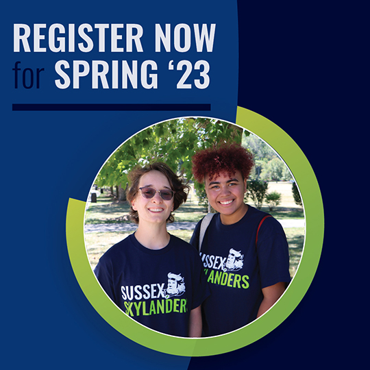 Two female students in matching Sussex shirts.
