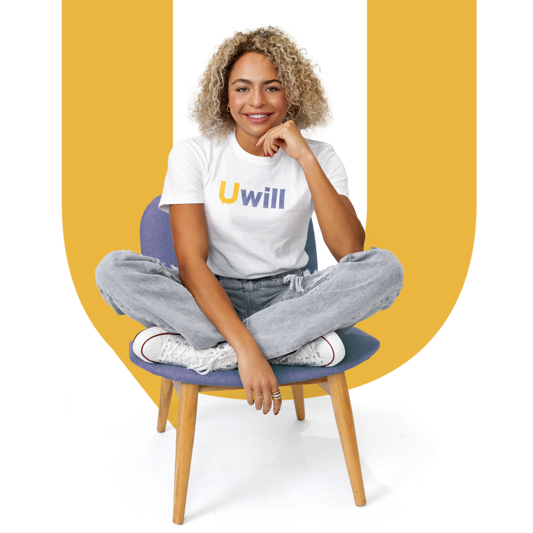 Woman sitting in a chair in front of the letter U.