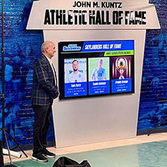 Man in front of Hall of Fame Wall