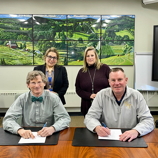 Four professionals sign an agreement