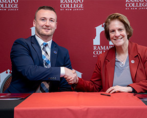 A man and woman pose for a professional photo.