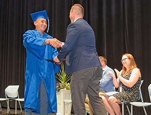 Preseident handing out diploma